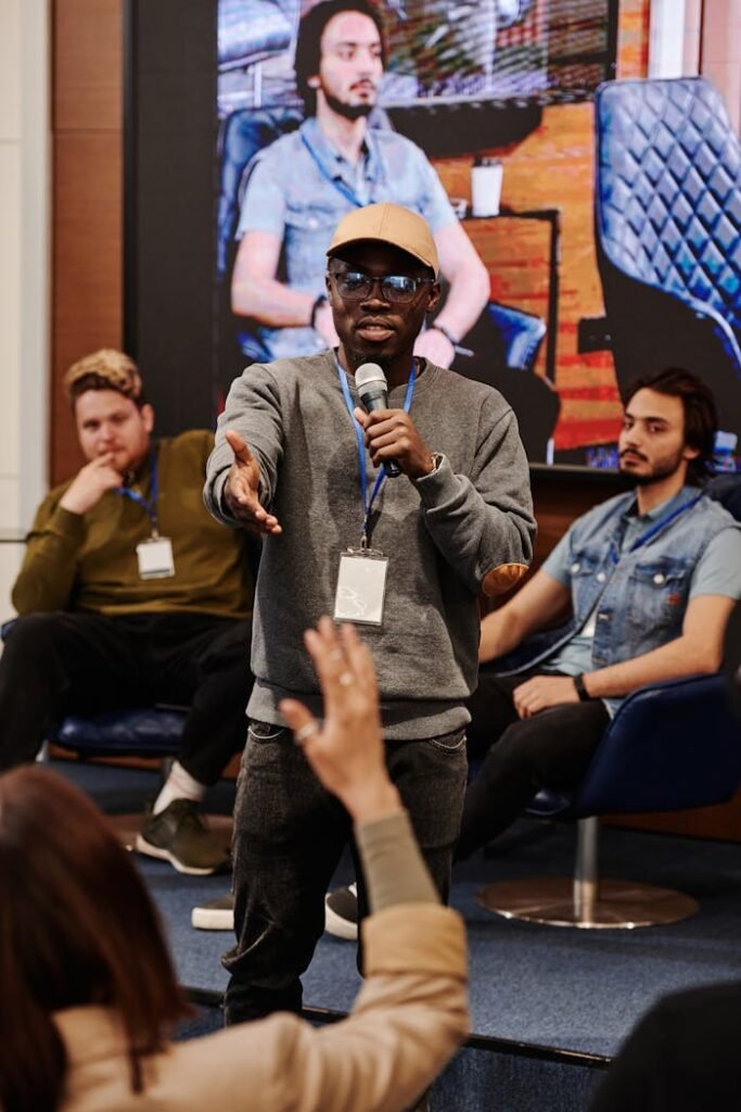 pexels photo 8348626 An interactive Q&A session with a diverse panel and engaged audience in a conference room setting.